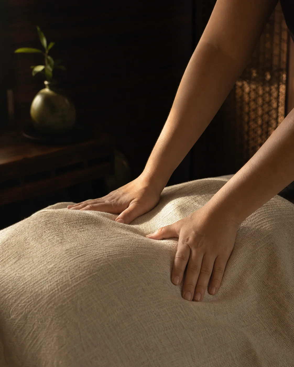 Professional palm pressure applied through a clean linen drape